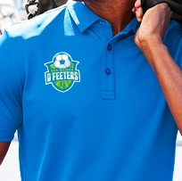 a direct to film print of a soccer logo on the left chest of a blue polo